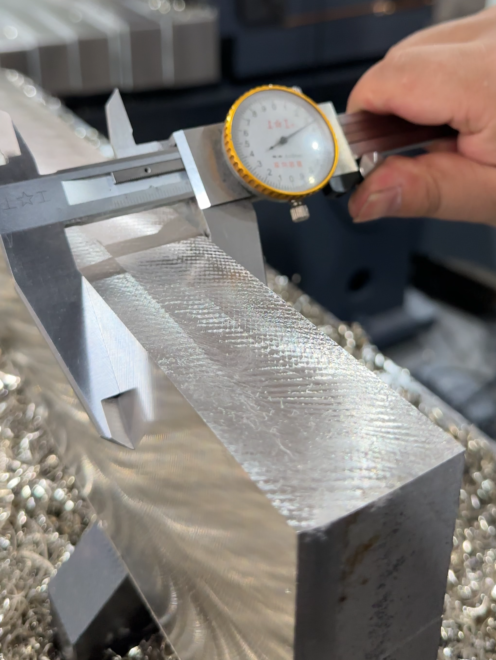 Dial measuring instrument checking a machined metal surface