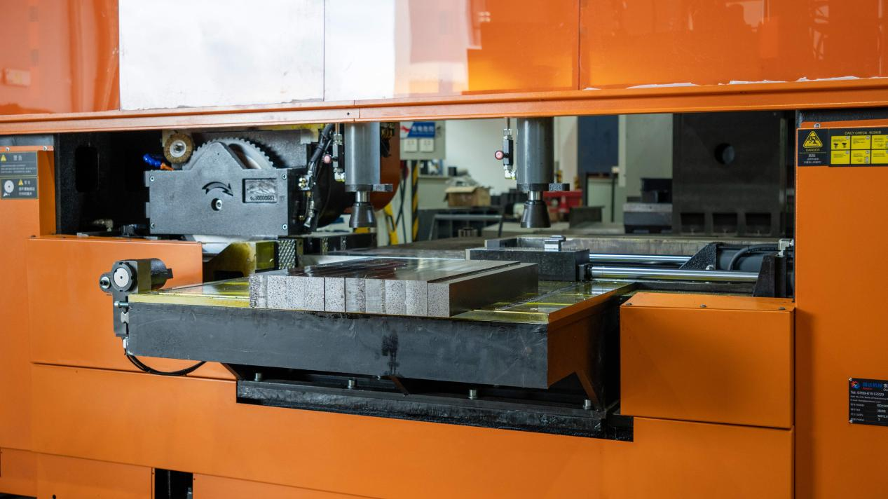 Industrial circular saw machine cutting a mold steel workpiece